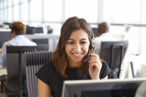 professional woman with headset in front of computer